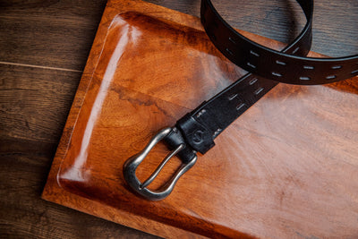 The Damian belt in black milled leather shown at full length, with dull nickel buckle
