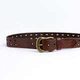 The Damian belt in cognac milled leather shown at full length, with dull brass buckle