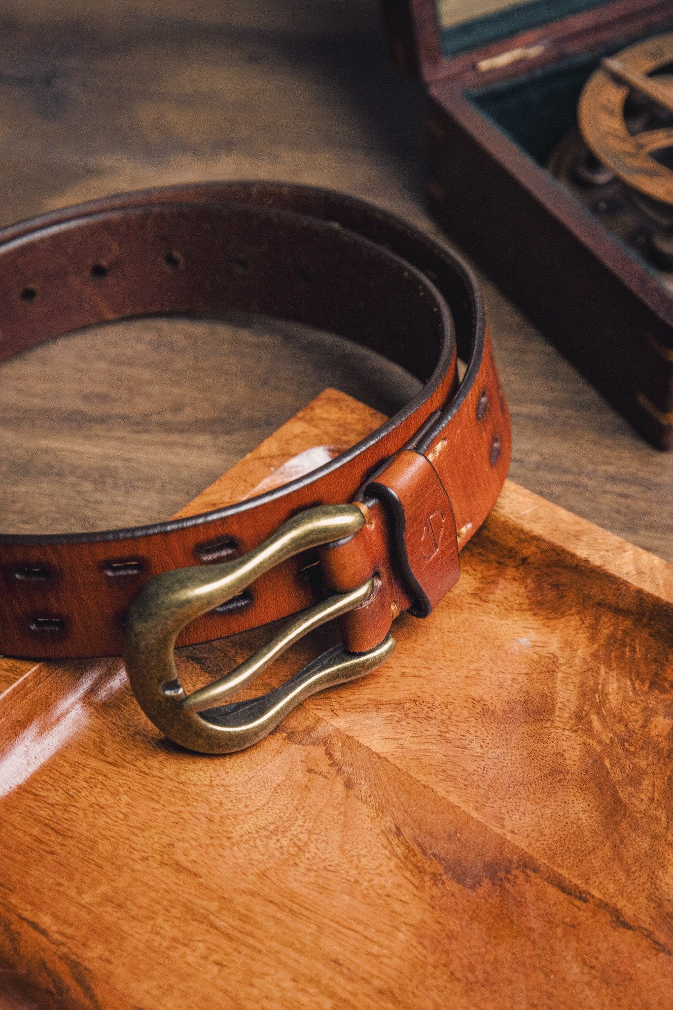 The Damian belt in tan milled leather, composed and at rest