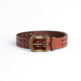 Close view of the dull brass buckle and hand-sewn buckle points on the Damian belt in tan