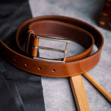 The Eduardo in Tan, Spanish full grain milled leather belt, composed still life