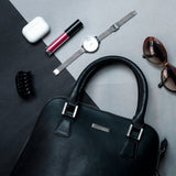 The Executive Handbag in black Spanish milled leather, styled.