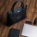 The Executive Laptop Bag in black, carried for the day.