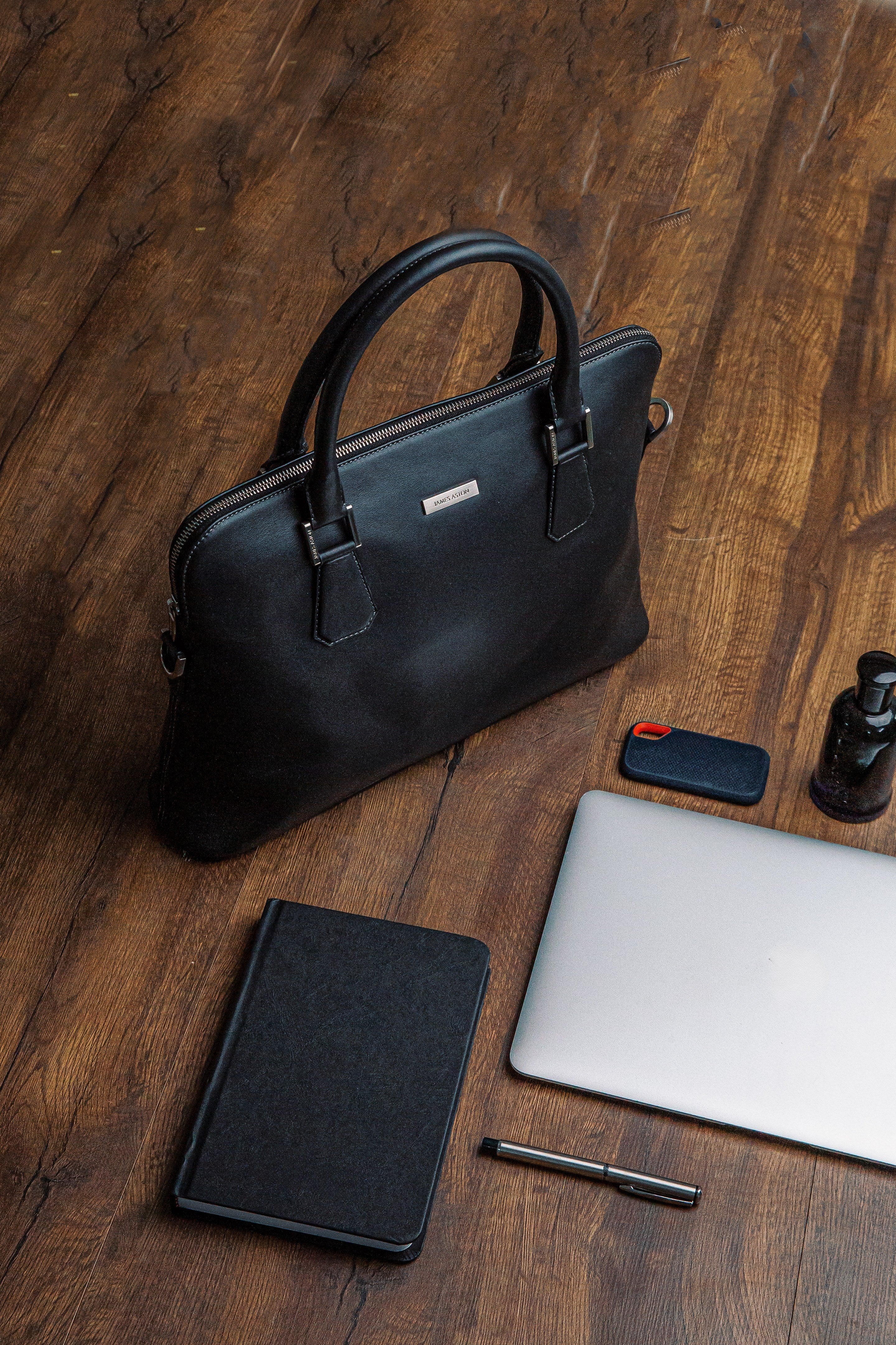 The Executive Laptop Bag in black, carried for the day.