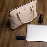 The Executive Laptop Bag in off-white, carried for the day.