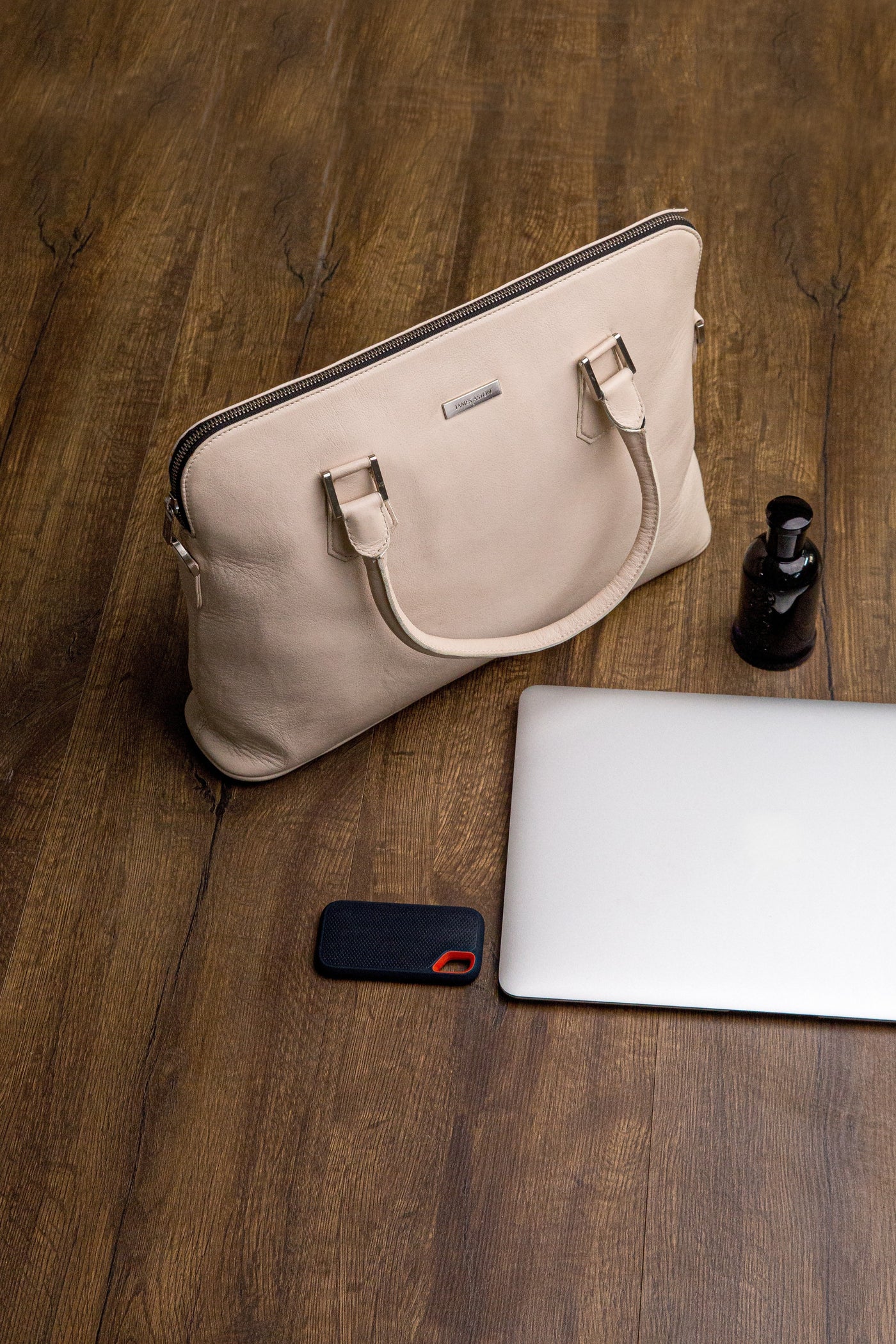 The Executive Laptop Bag in off-white, carried for the day.