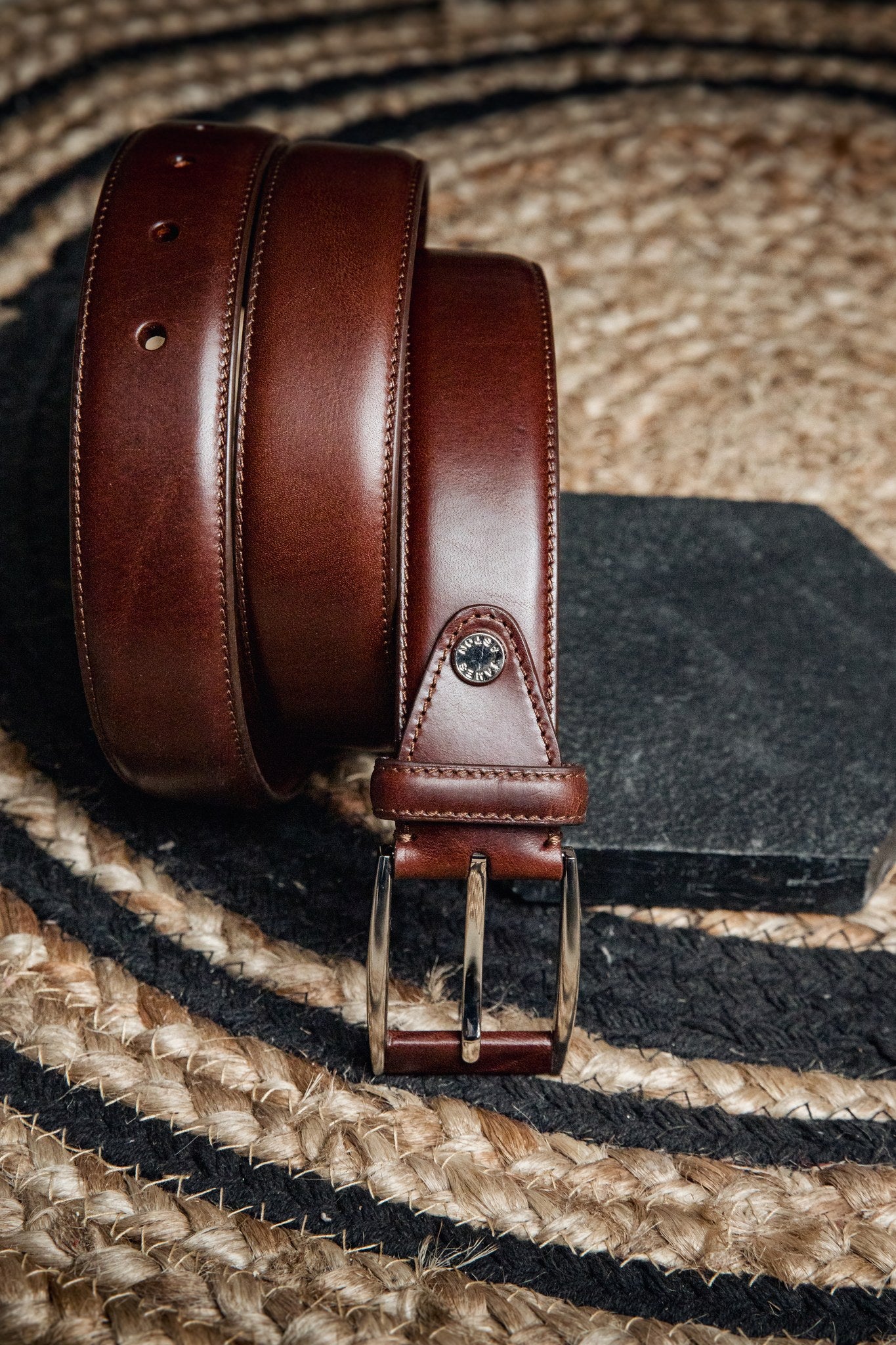 The Federico belt in Australian Nut Italian Full Grain Vachetta leather, composed and at rest