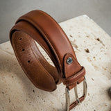 Detail of the cognac Italian Full Grain Vachetta leather and feather-edged stitching of the Federico belt