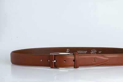 The Federico belt in cognac Italian Full Grain Vachetta leather shown at full length, with brushed nickel buckle