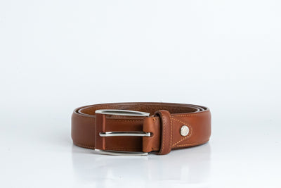 Close view of the brushed nickel buckle and solid brass screw on the Federico belt in cognac