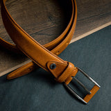 Detail of the tan Italian Full Grain Vachetta leather and feather-edged stitching of the Federico belt