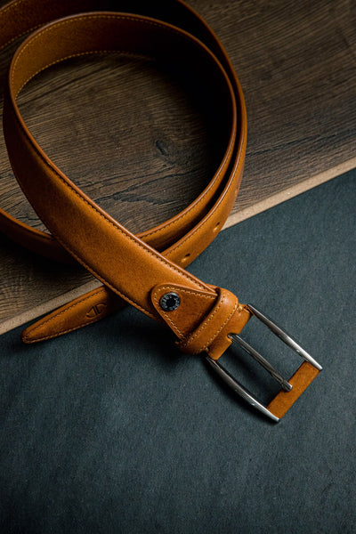 Detail of the tan Italian Full Grain Vachetta leather and feather-edged stitching of the Federico belt
