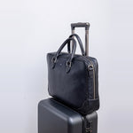 Side profile of The Mentor black leather laptop bag.