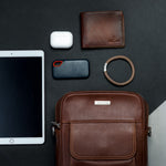 The Minimal Sling cognac crossbody bag, the few things that matter kept to hand.