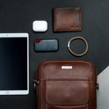 The Minimal Sling cognac crossbody bag, the few things that matter kept to hand.