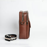 Side profile of The Minimal Sling cognac leather sling bag.