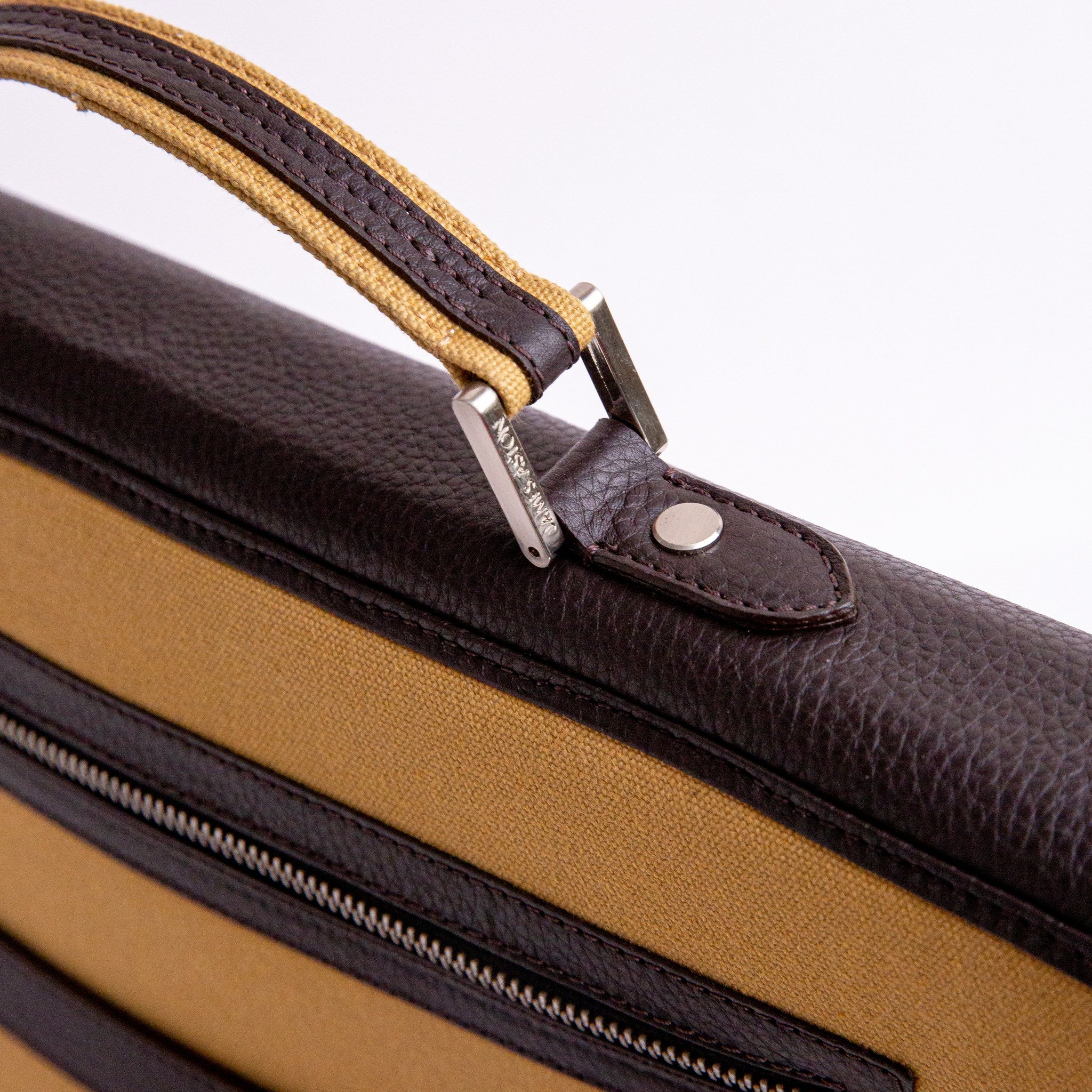 Brushed nickel metalware and YKK zip on The Motivator khaki beige canvas briefcase.