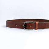 The Pedro belt in cognac milled leather shown at full length, with silver finish buckle