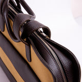 Close view of the cotton canvas and Spanish leather trim on The Risk-Taker, khaki beige.