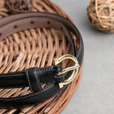 The natural Vachetta leather of the Vittoria dress belt in black.
