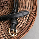 The grain of the Vachetta leather of the Vittoria dress belt in black, up close.