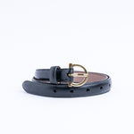 The gold buckle of the Vittoria Vachetta dress belt in black.