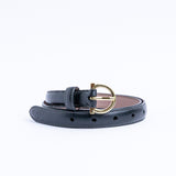 The gold buckle of the Vittoria Vachetta dress belt in black.