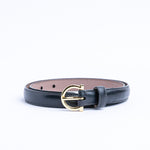 The Vittoria dress belt in black Italian Vachetta leather, coiled.