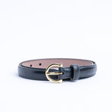 The Vittoria dress belt in black Italian Vachetta leather, coiled.