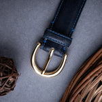 The natural Vachetta leather of the Viviana dress belt in blue.
