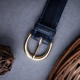 The natural Vachetta leather of the Viviana dress belt in blue.