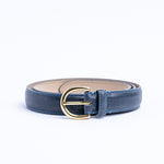 The gold buckle of the Viviana Vachetta dress belt in blue.