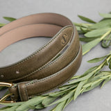 The grain of the Vachetta leather of the Viviana dress belt in olive, up close.