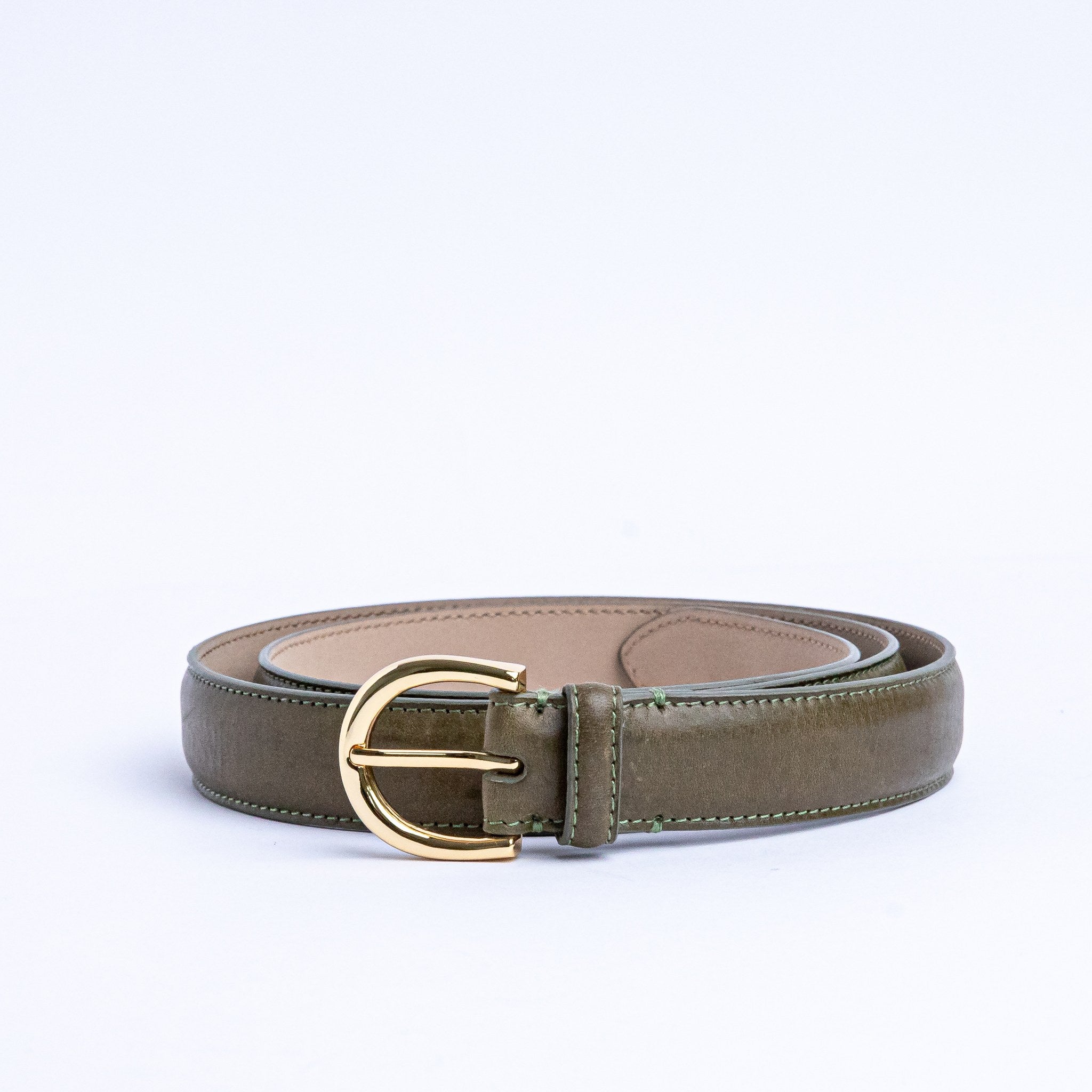 The gold buckle of the Viviana Vachetta dress belt in olive.