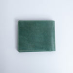 The back of the Zanebono Bifold I wallet in sea green smooth Vachetta leather.