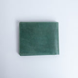 The back of the Zanebono Bifold I wallet in sea green smooth Vachetta leather.