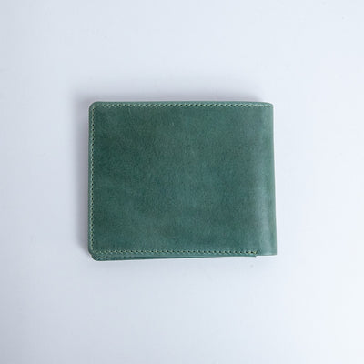 The back of the Zanebono Bifold I wallet in sea green smooth Vachetta leather.