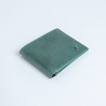The Zanebono Bifold I wallet in sea green smooth Vachetta leather.