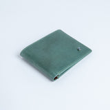The Zanebono Bifold I wallet in sea green smooth Vachetta leather.