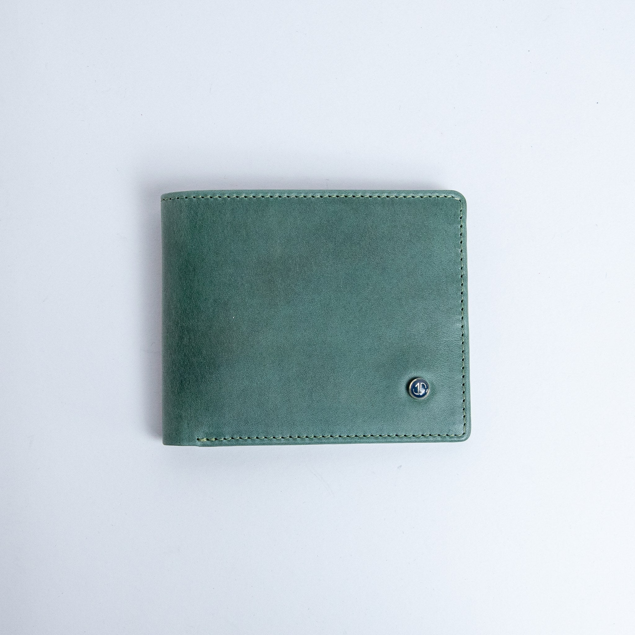 The Zanebono Bifold I wallet in sea green smooth Vachetta leather, closed.