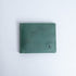 The Zanebono Bifold I wallet in sea green smooth Vachetta leather, closed.