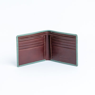 The interior of the Zanebono Bifold I wallet in sea green, showing eight card slots and cash compartments.