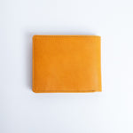 The back of the Zanebono Bifold II wallet in tan smooth Vachetta leather.