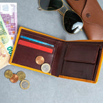 The smooth Vachetta leather of the Zanebono Bifold II wallet in tan.