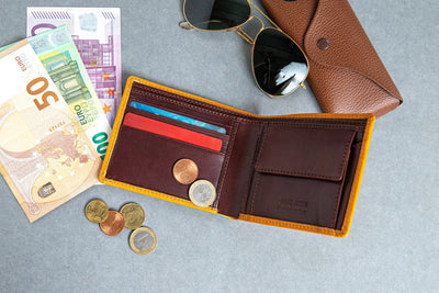 The smooth Vachetta leather of the Zanebono Bifold II wallet in tan.
