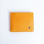 The Zanebono Bifold II wallet in tan smooth Vachetta leather, closed.