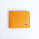 The Zanebono Bifold II wallet in tan smooth Vachetta leather, closed.