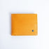 The Zanebono Bifold II wallet in tan smooth Vachetta leather, closed.