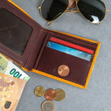 The smooth Vachetta leather of the Zanebono With Flap I wallet in tan.