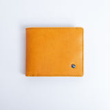 The Zanebono With Flap I wallet in tan smooth Vachetta leather, closed.